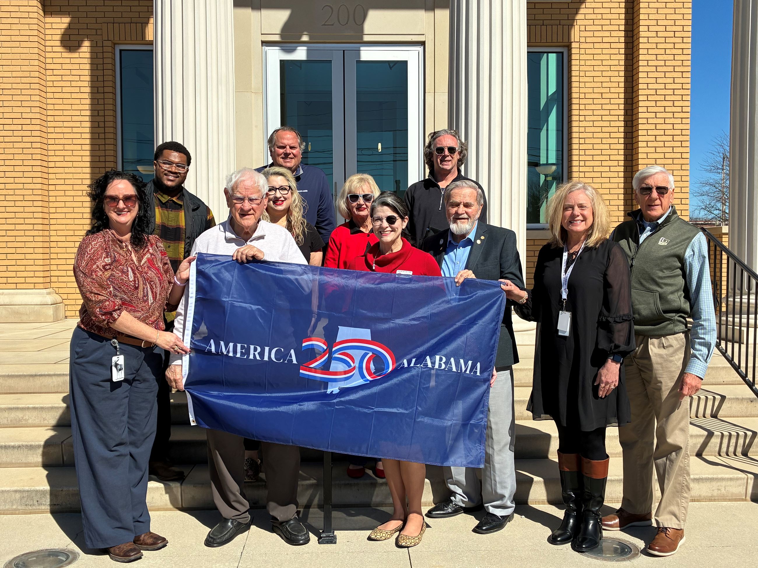 The local America250AL Committee with flag